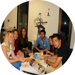 travelers eating food around table
