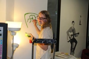 girl painting eco friendly logo acyh